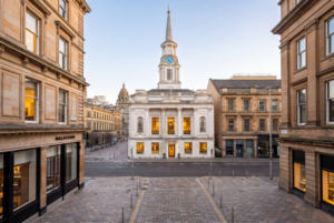 Hutchesons' Hall illuminated at dusk on Ingram Street, home to Saints of Ingram restaurant and events venue in the heart of Glasgow's Merchant City
